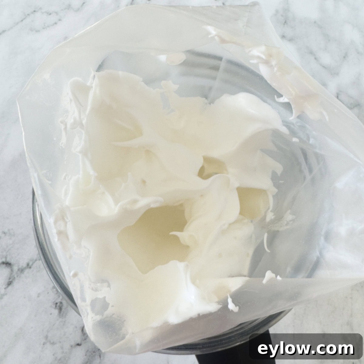 Zesty Lemon Meringue Tart 11 Piping bag filled with Italian meringue ready to be piped onto a tart.