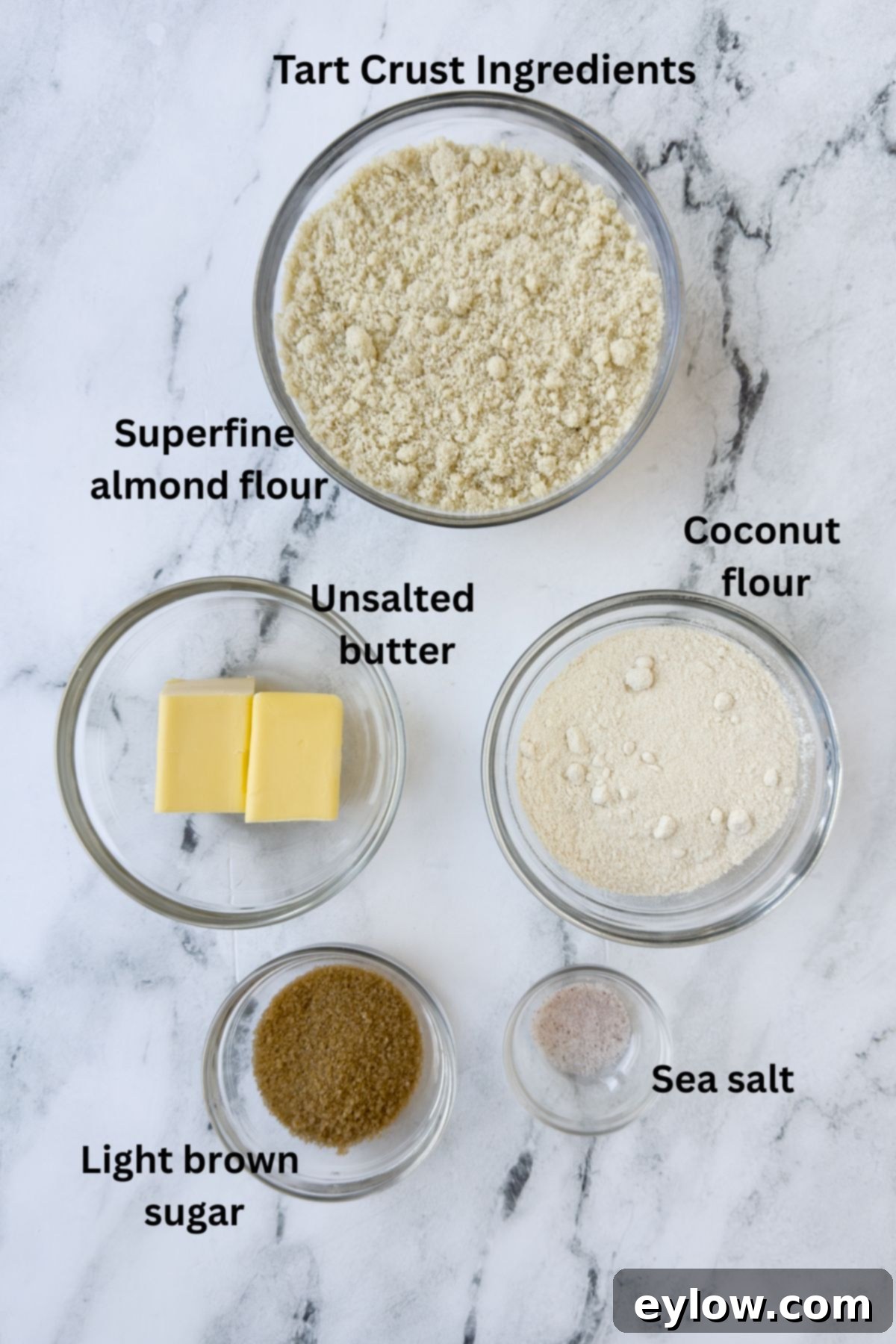 Zesty Lemon Meringue Tart 3 Ingredients for an almond flour tart crust in prep bowls on a counter.