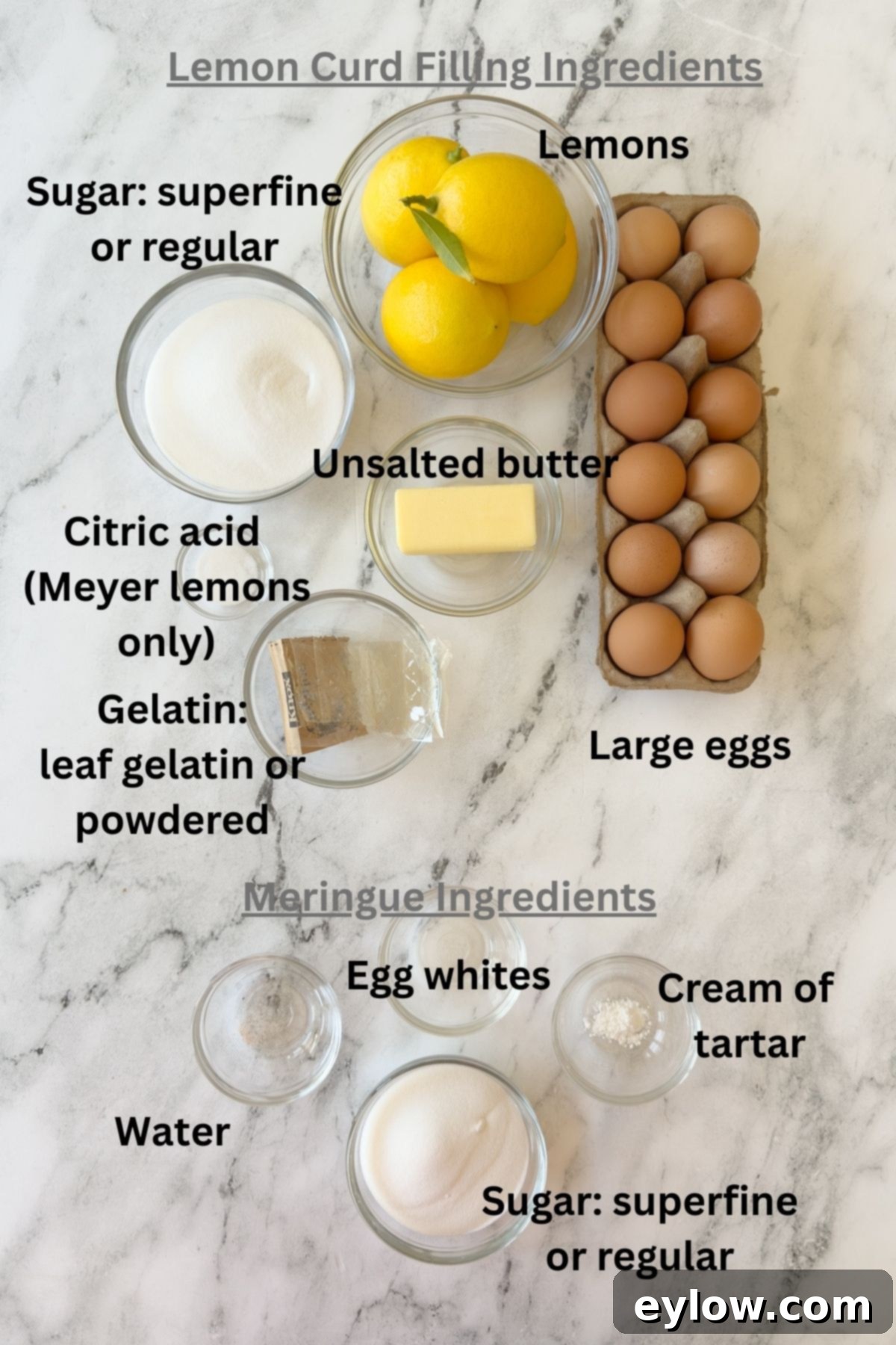 Zesty Lemon Meringue Tart 4 Ingredients for a lemon meringue tart in prep bowls on a marble counter.
