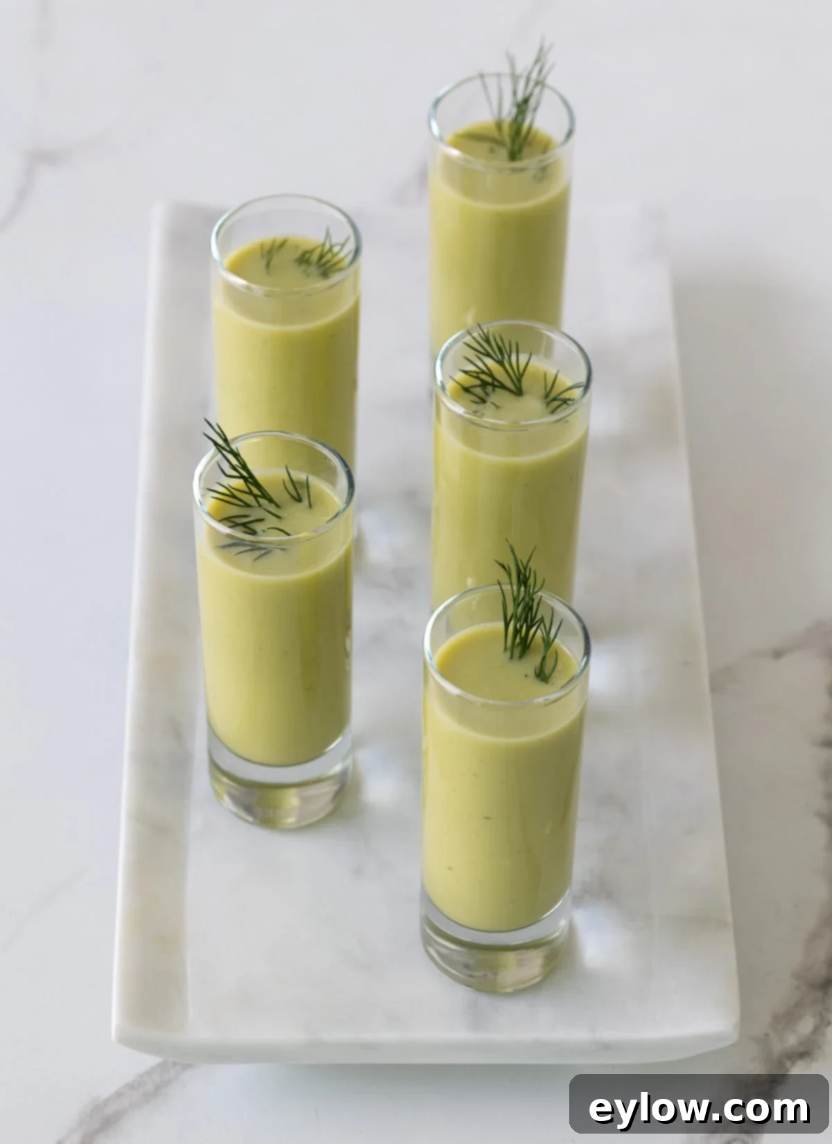 Asparagus soup shooters presented as elegant appetizers.