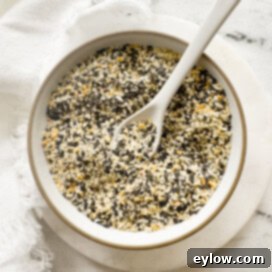 DIY Everything Bagel Seasoning 4 Small bowl of homemade everything but the bagel seasoning with seeds, garlic, and onion.