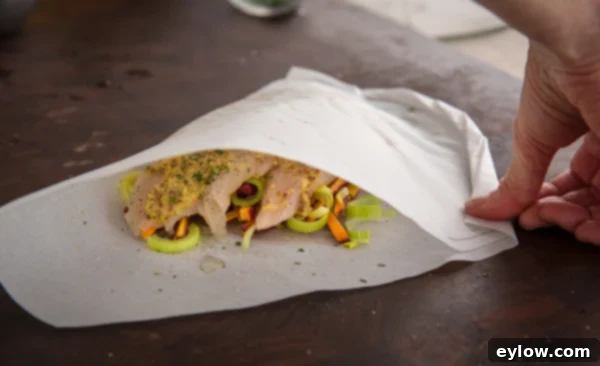 Completely sealed parchment chicken packet, ready for baking