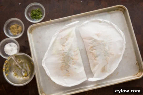 Opened parchment packet with perfectly baked chicken and vegetables