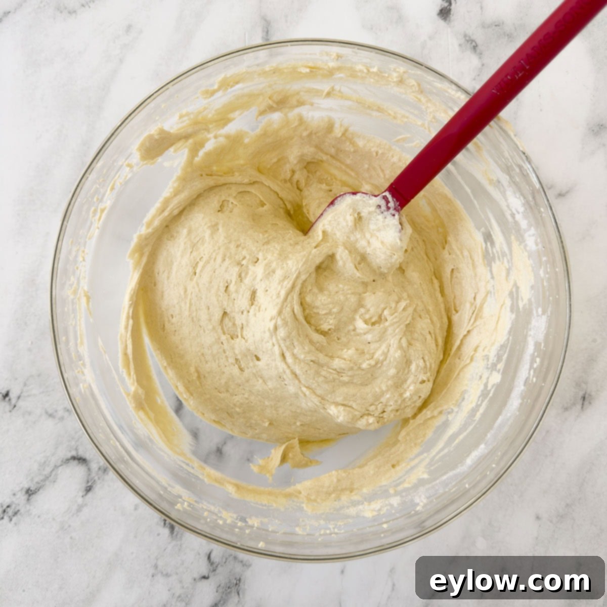 Artisan Gluten-Free Cream Cheese Pound Cake 11 Finished pound cake batter in a bowl with a spatula.