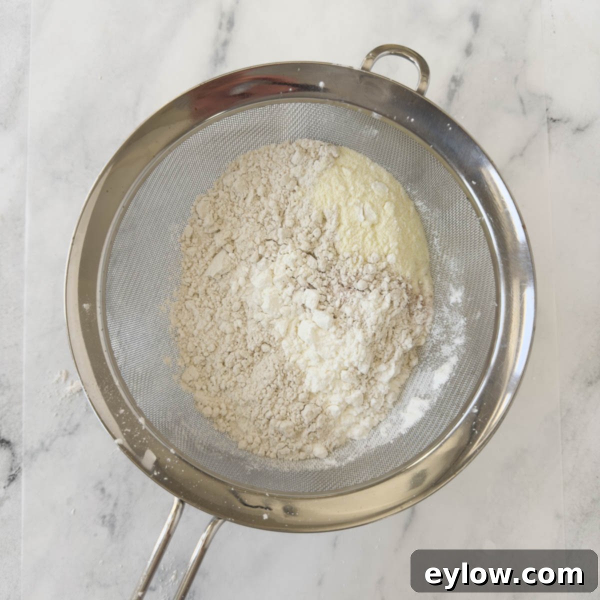 Artisan Gluten-Free Cream Cheese Pound Cake 10 Flour, salt, cornstarch, and milk powder in a sieve for sifting.