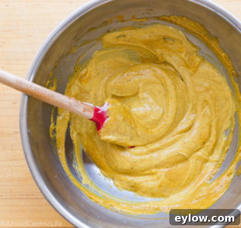 Close-up of golden curry dressing ingredients, showcasing the vibrant spices.