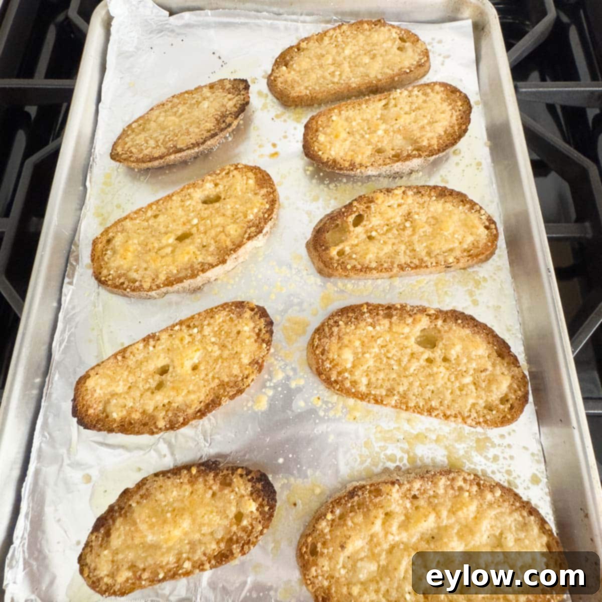 Golden, cheesy, broiled gluten-free garlic toast with a perfectly melted Parmesan topping, ready to be enjoyed.