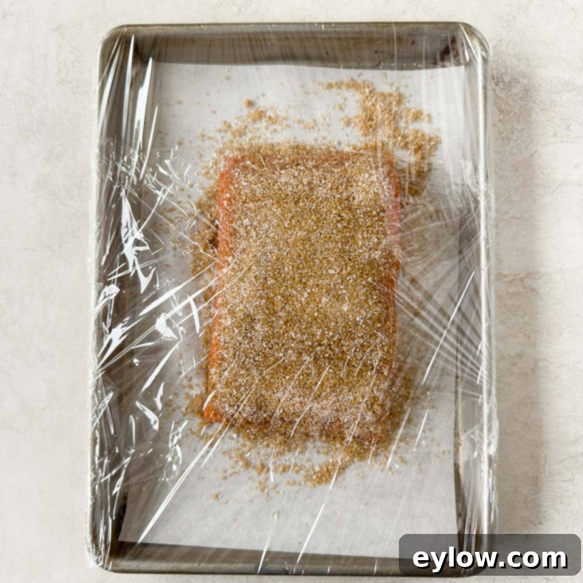 Pellet Grill Smoked Salmon Perfection 6 Plastic wrapped salmon fillet covered in smoking cure for the curing phase.