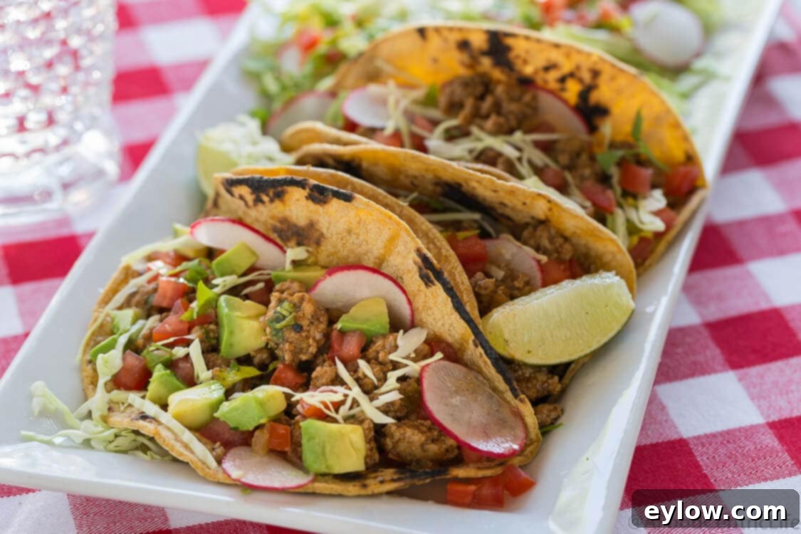 A vibrant close-up of a finished taco, overflowing with savory ground meat, fresh cabbage, cilantro, and a squeeze of lime, showcasing a perfectly prepared 10-minute turkey taco filling.