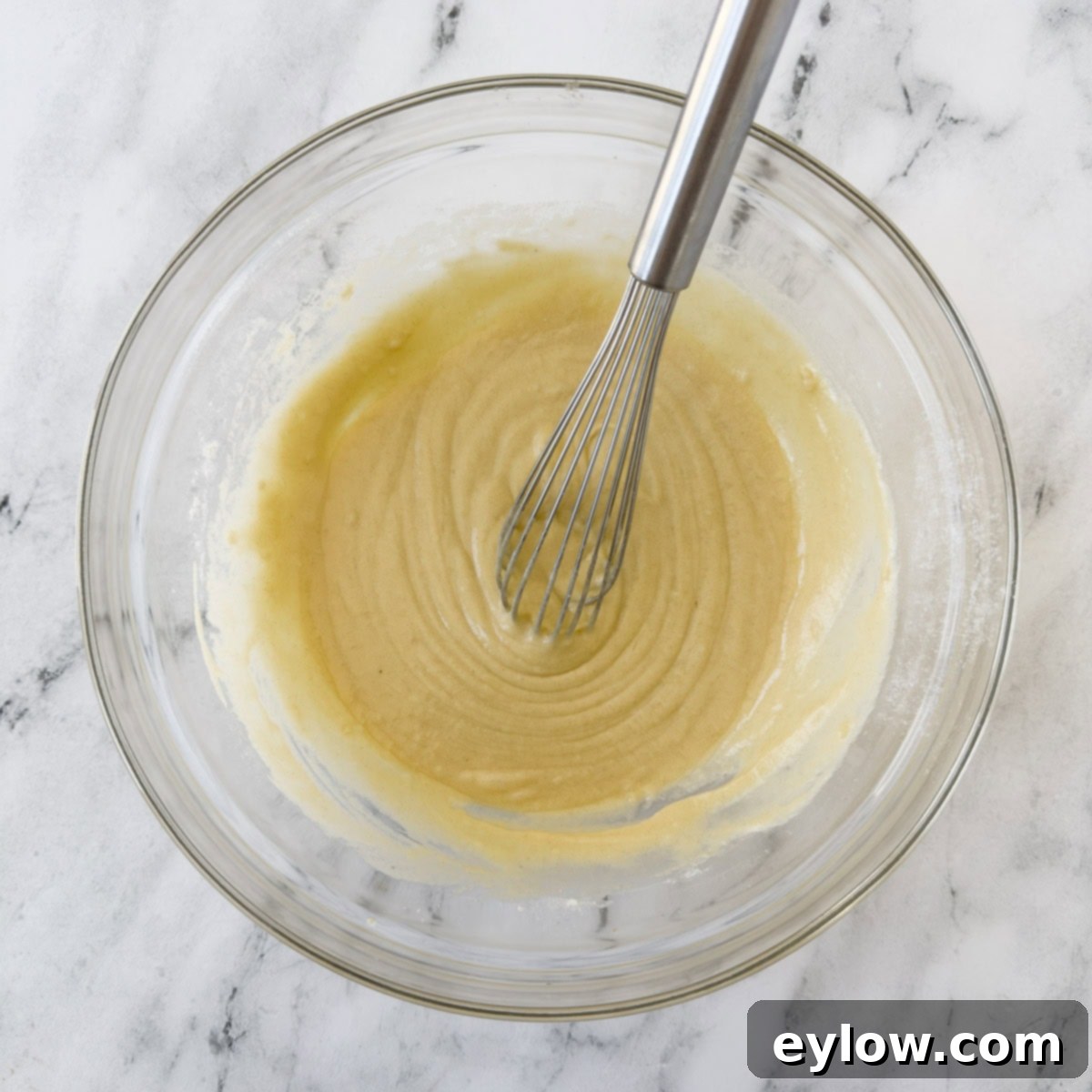 Smooth whisked batter to pour over a peach cobbler. 