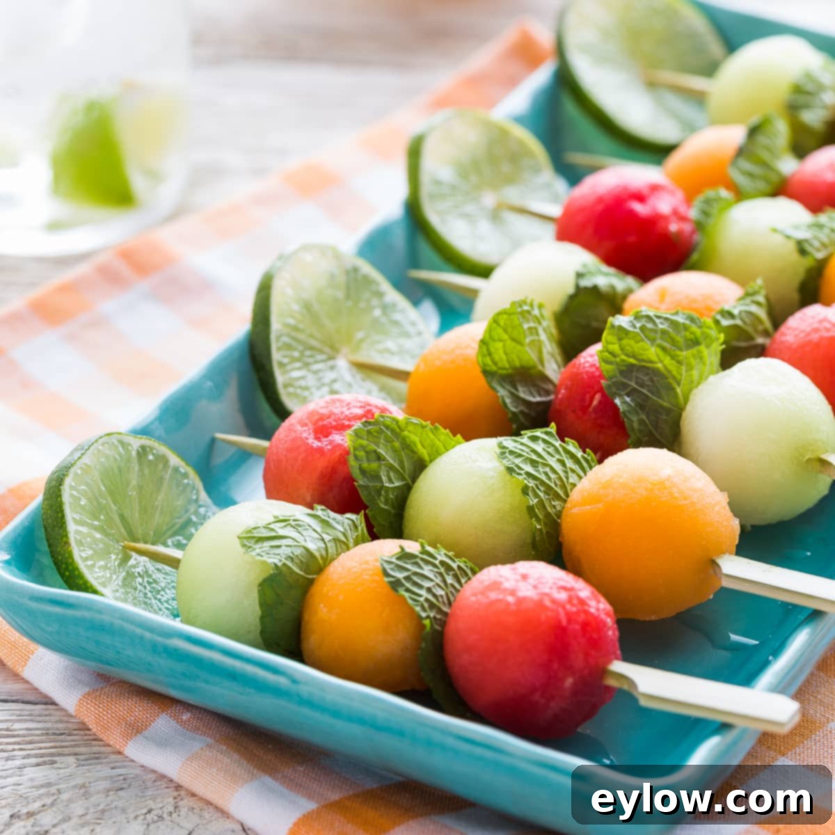 Fruit kabobs with watermelon, cantaloupe, and honeydew melons. 