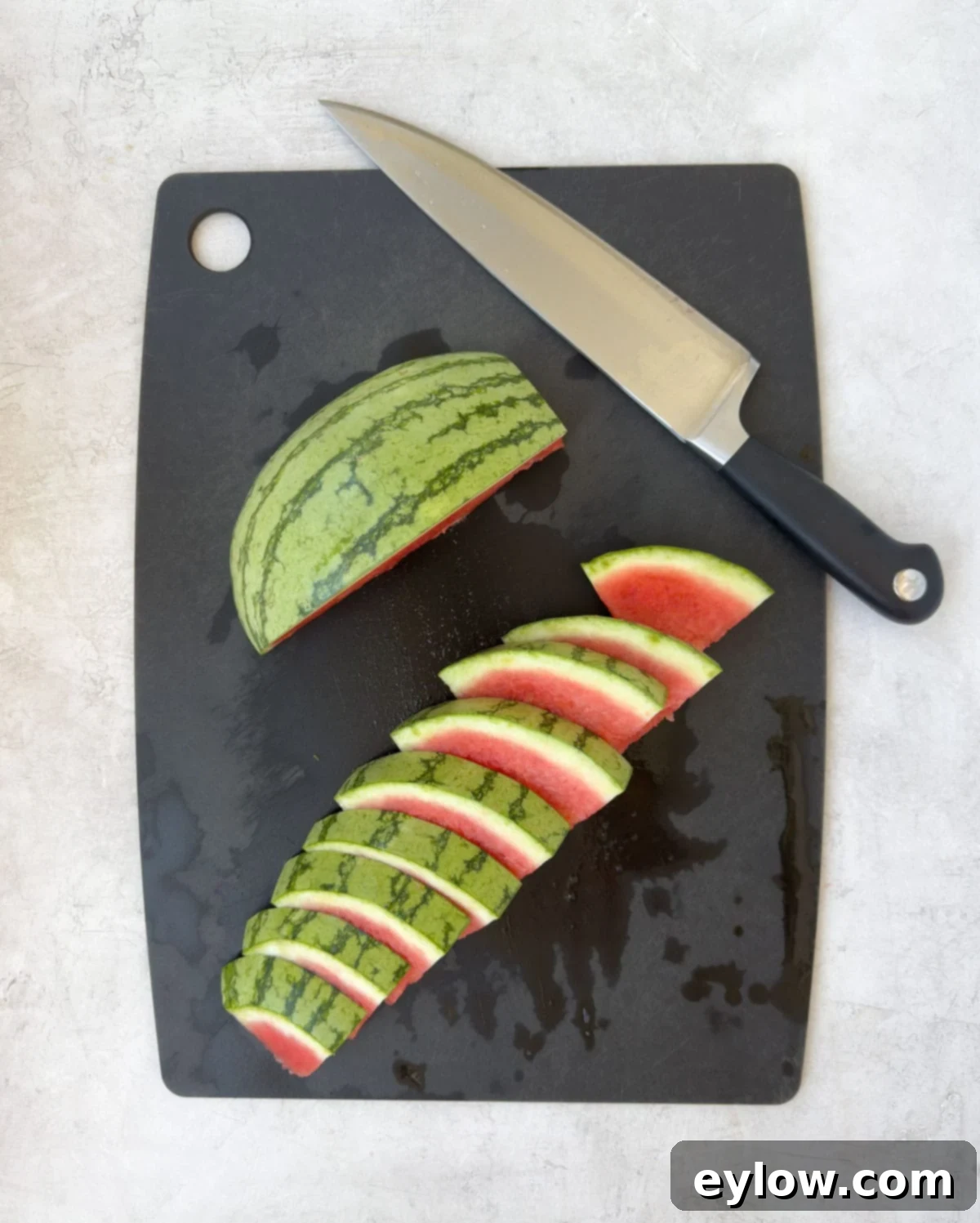 Showing how to cut watermelon slices from a quarter melon. 