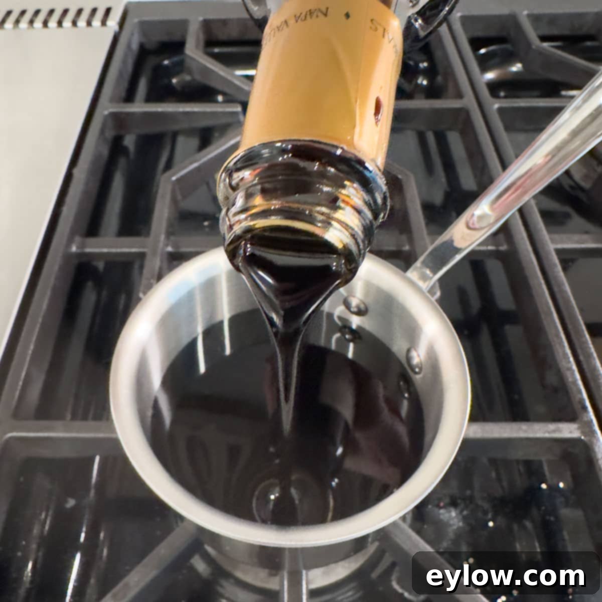 Homemade Balsamic Glazed Strawberries 4 Pouring balsamic vinegar into a small pan for reducing into glaze.