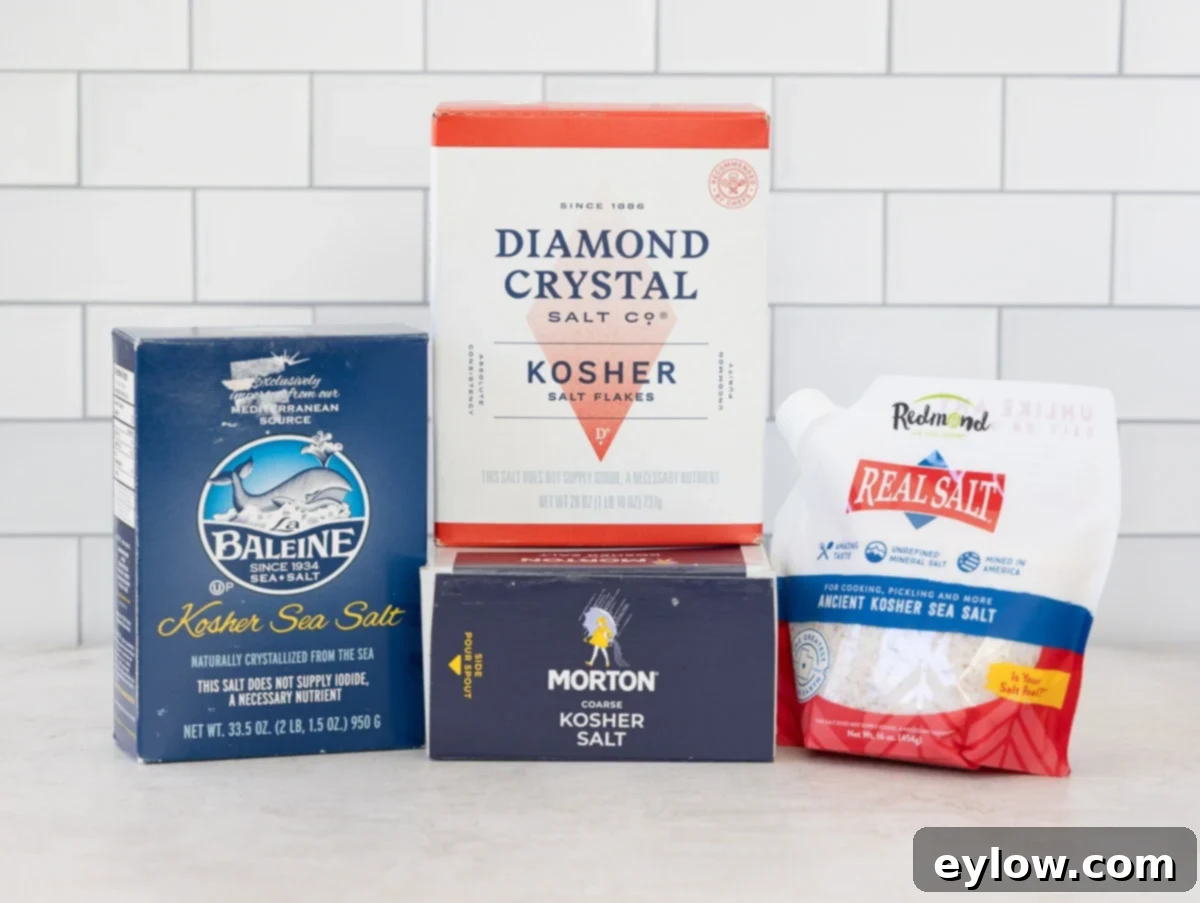 Boxes of different kosher salts for brining on a kitchen counter, highlighting the variety and importance of measurement.