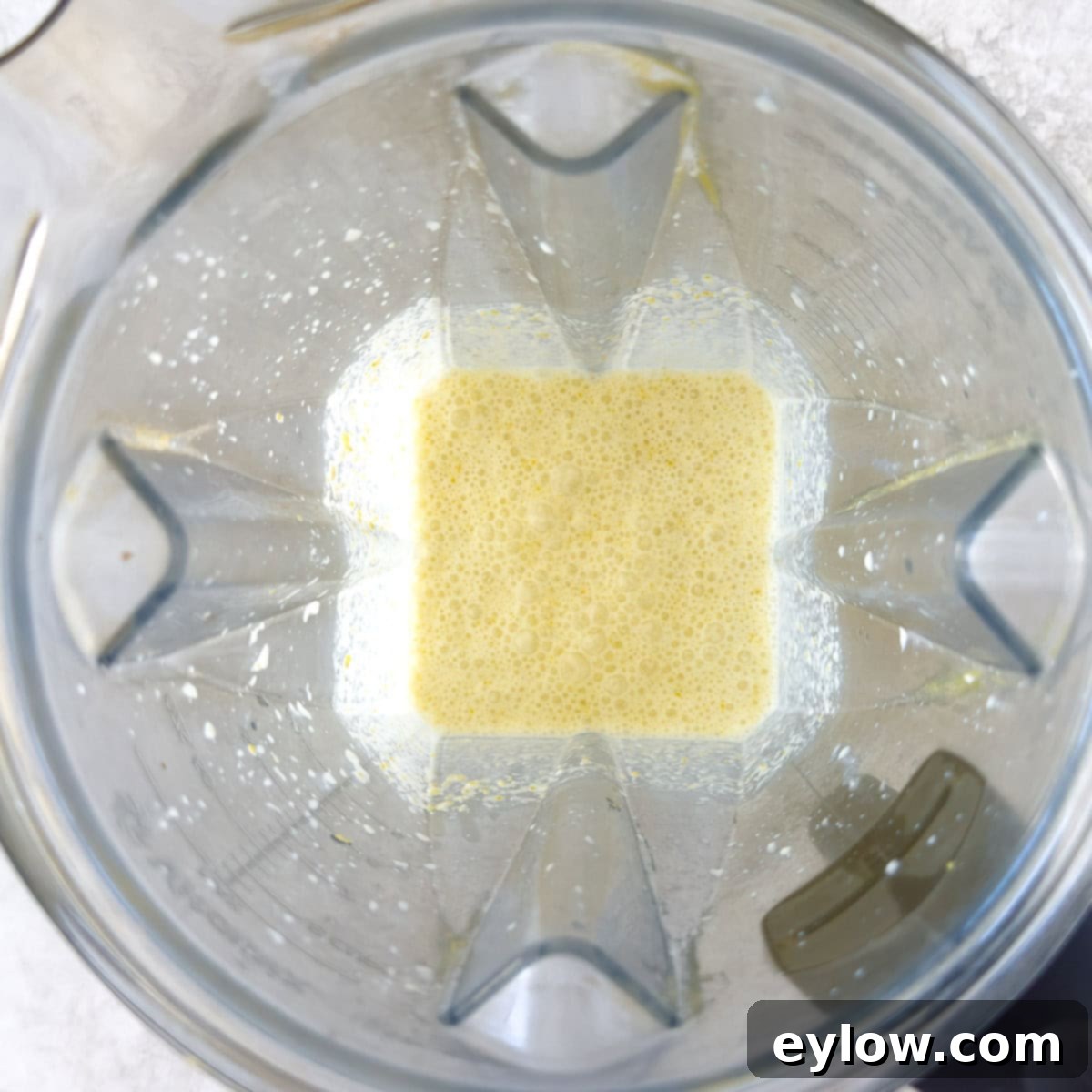 Pureed corn and half and half in a blender from the top down.