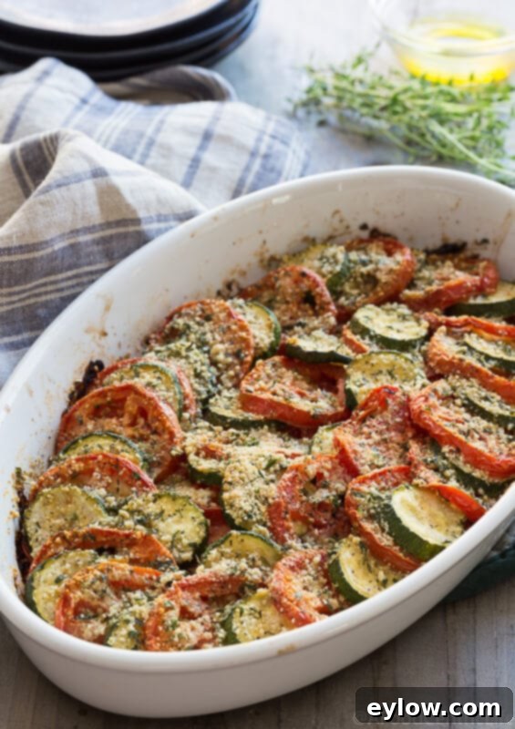 tomato zucchini casserole | AFoodCentricLife.com A finished zucchini tomato gratin, baked to perfection with a golden-brown, crispy parmesan and breadcrumb topping.
