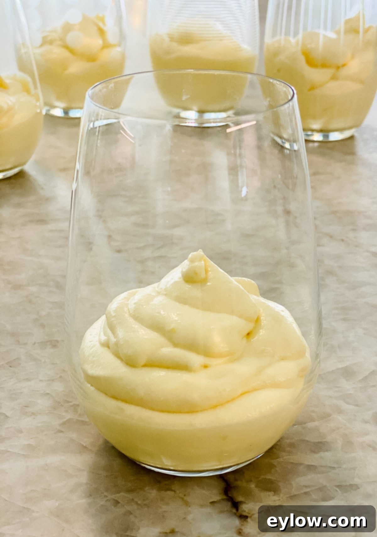Whip Up Luscious Lemon Mousse 4 Fluffy, light lemon mousse elegantly presented in a glass, ready for enjoyment.