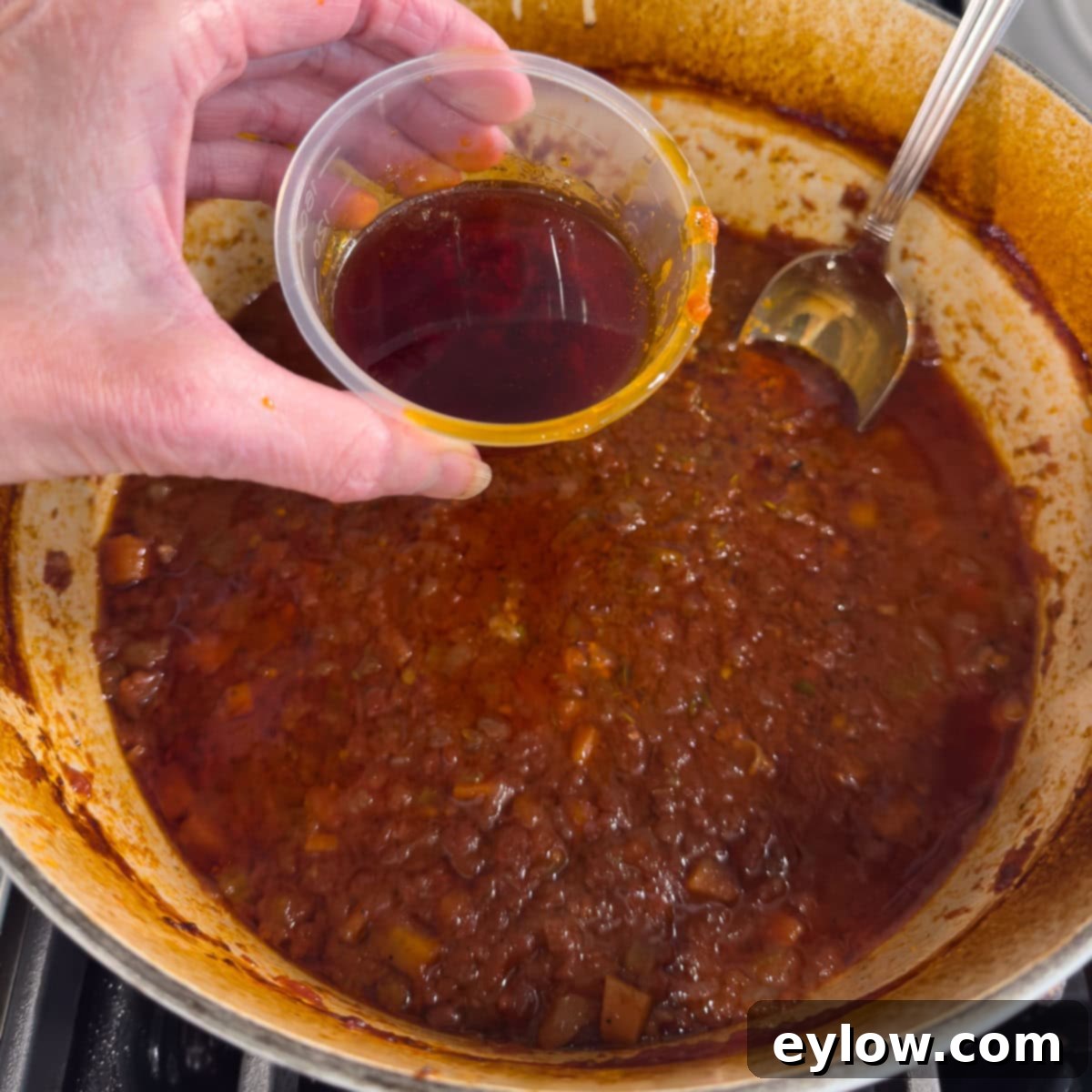 Rich Braised Beef Short Rib Ragu 14 Degreasing a pot of braised beef ribs.
