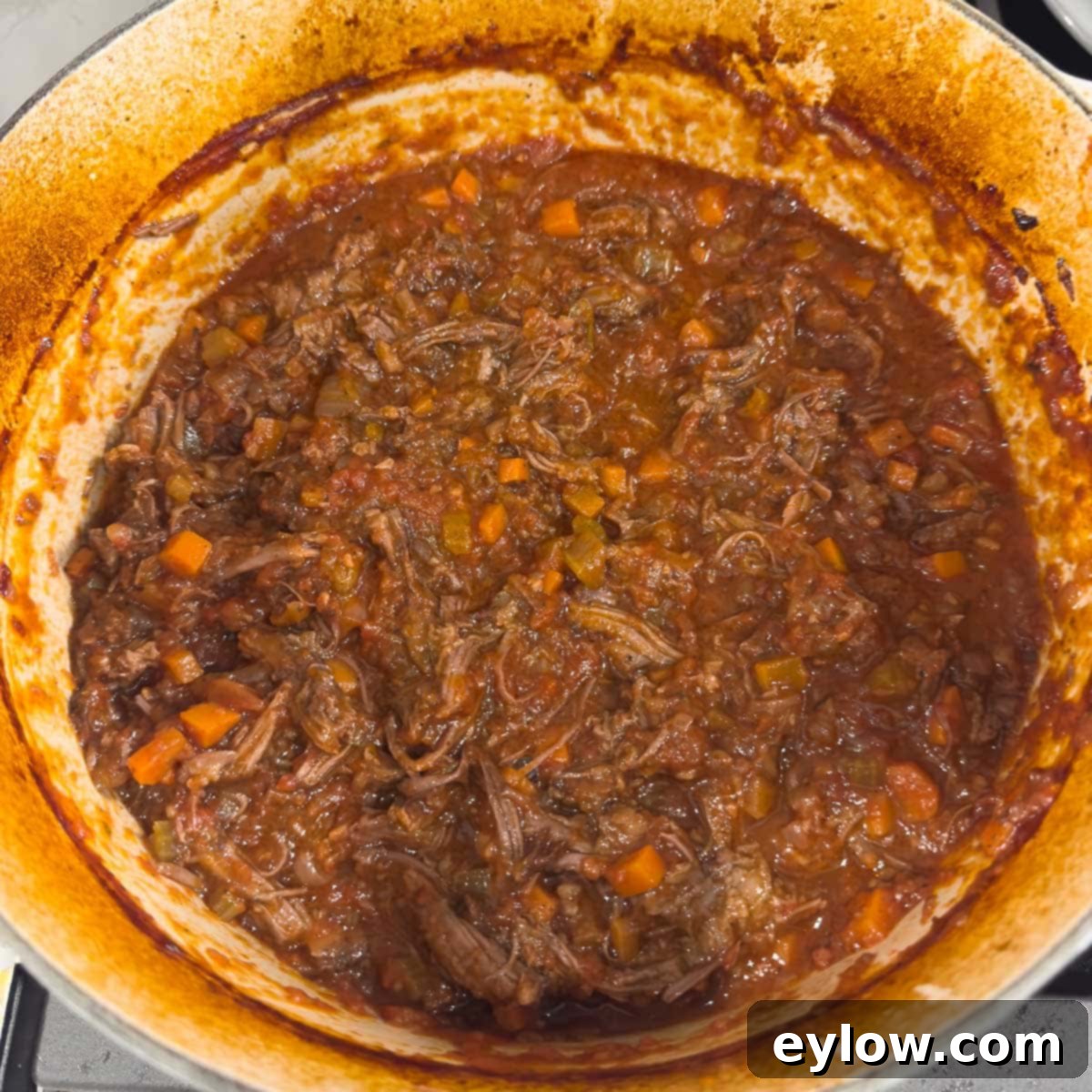 Rich Braised Beef Short Rib Ragu 15 Shredded Italian short rib ragu in a dutch oven, ready to serve