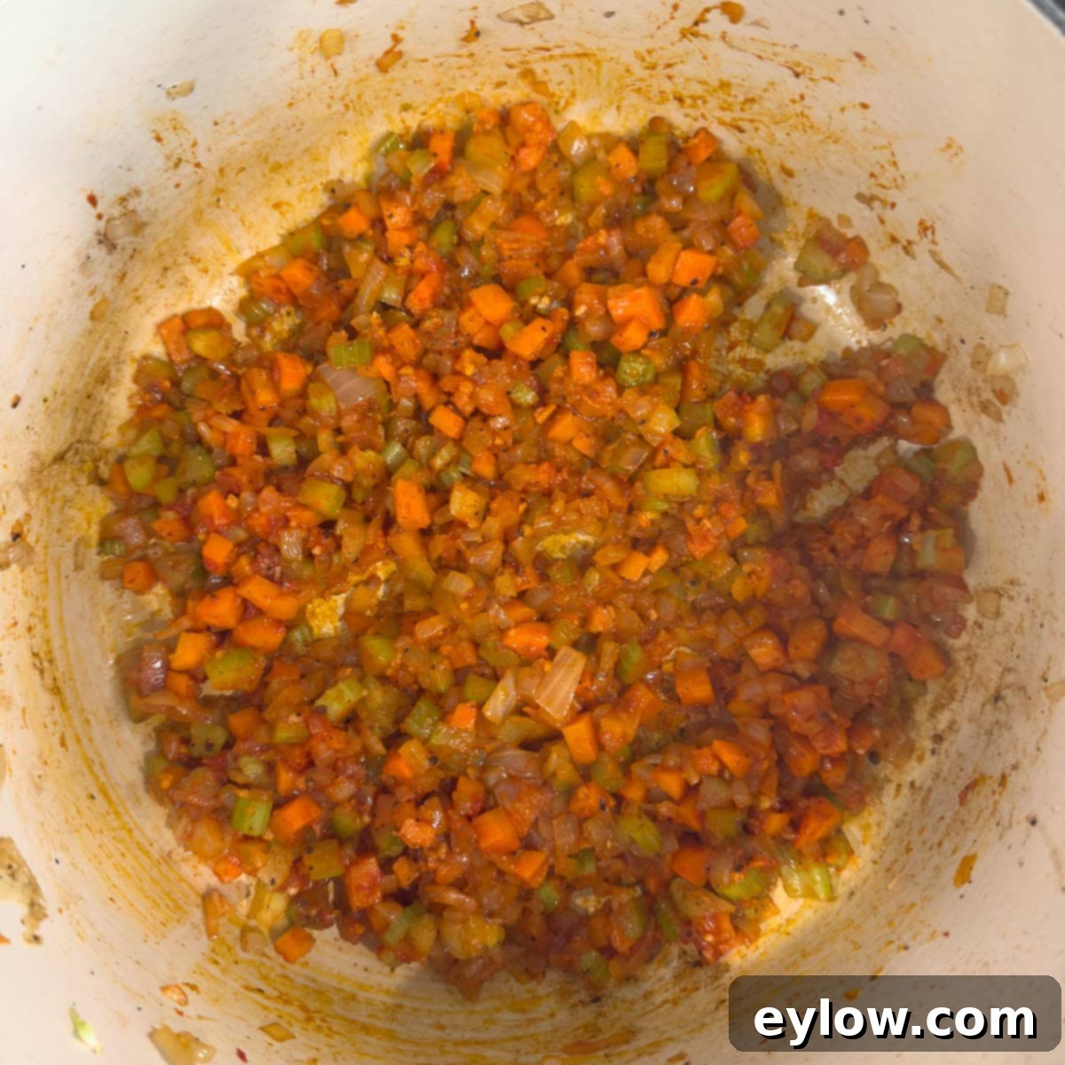 Rich Braised Beef Short Rib Ragu 7 Brick red sautéed vegetables after the addition of tomato paste.