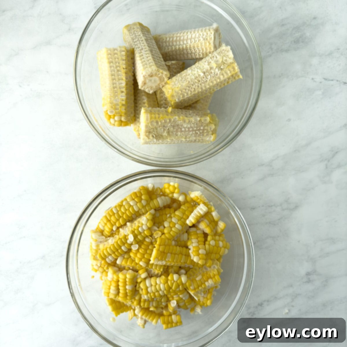 Slicing cooked corn kernels off the cob for succotash.