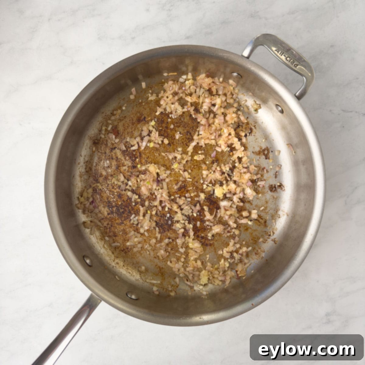 Cooking shallots and garlic in a saute pan.