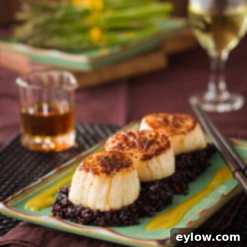 Beautifully seared scallops with orange miso sauce, served with forbidden black rice.