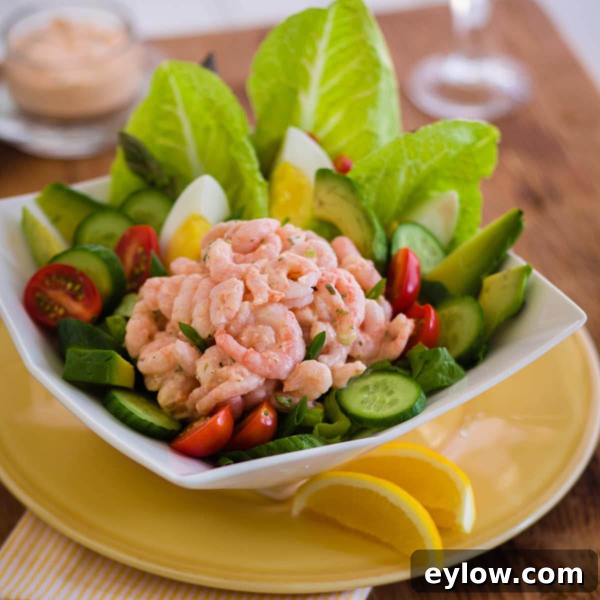 Vibrant Shrimp Louie salad with plump shrimp, fresh vegetables, and crisp lettuce, ready to be enjoyed.
