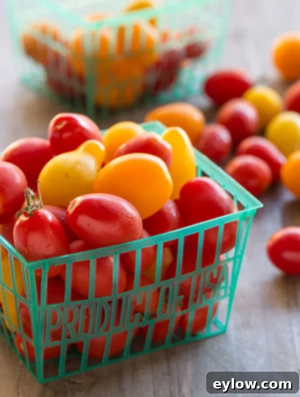 Baskets overflowing with ripe grape and cherry tomatoes, showcasing their vibrant red and orange colors.