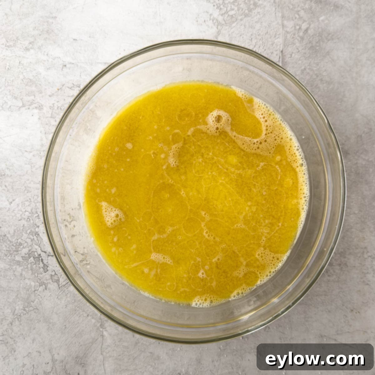 Fluffy Gluten-Free Waffles 5 Wet ingredients for waffle batter in a glass bowl.