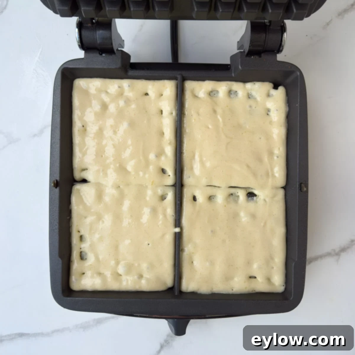 Fluffy Gluten-Free Waffles 8 Gluten-free waffle batter spread into the waffle maker.