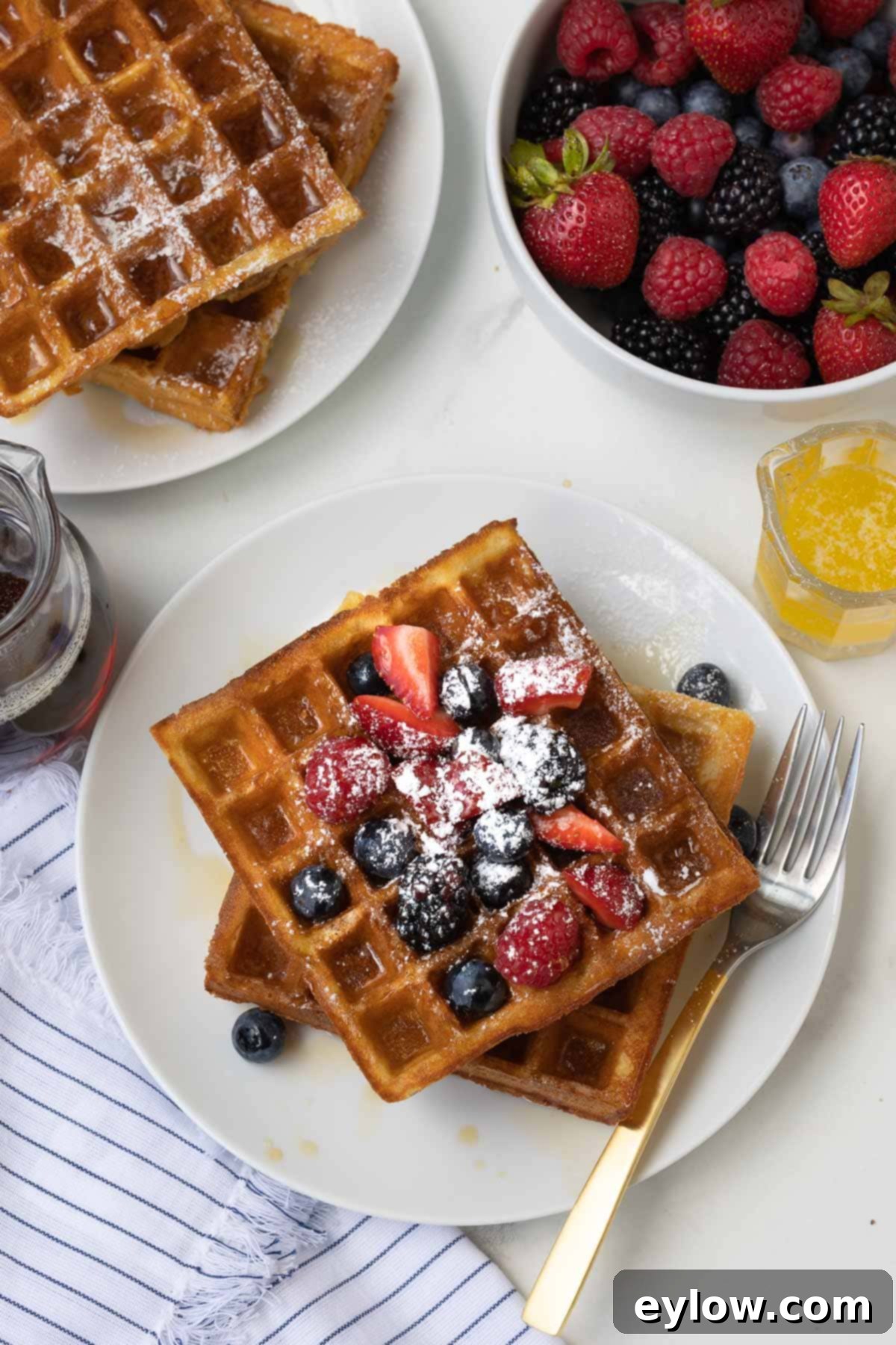 Fluffy Gluten-Free Waffles 10 Plates of golden Belgian waffles with fresh berries and maple syrup.