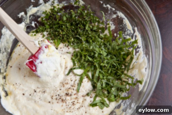 Lasagna ricotta filling in a mixing bowl, ready for layering.