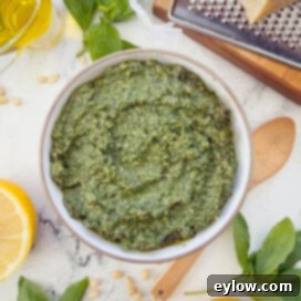 Genovese Basil Pesto: The Original Italian Recipe 7 A bowl of bright green Genovese pesto, classic Italian basil pesto.