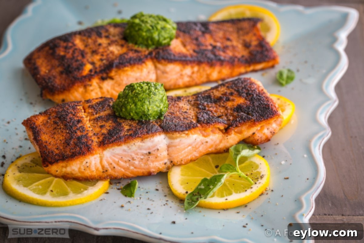 Genovese Basil Pesto: The Original Italian Recipe 5 A perfectly seared salmon fillet, garnished with fresh herbs and a vibrant green sauce, hints at a delightful pairing with Pesto Genovese.