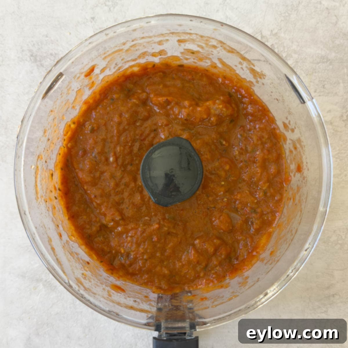 Pureed tomato sauce in a food processor workbowl ready to enjoy.