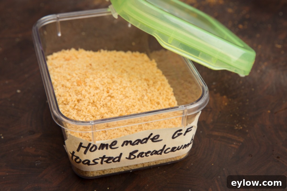 Golden Parmesan Zucchini Gratin 5 A clear container filled with golden, toasted homemade bread crumbs, labeled for easy identification.