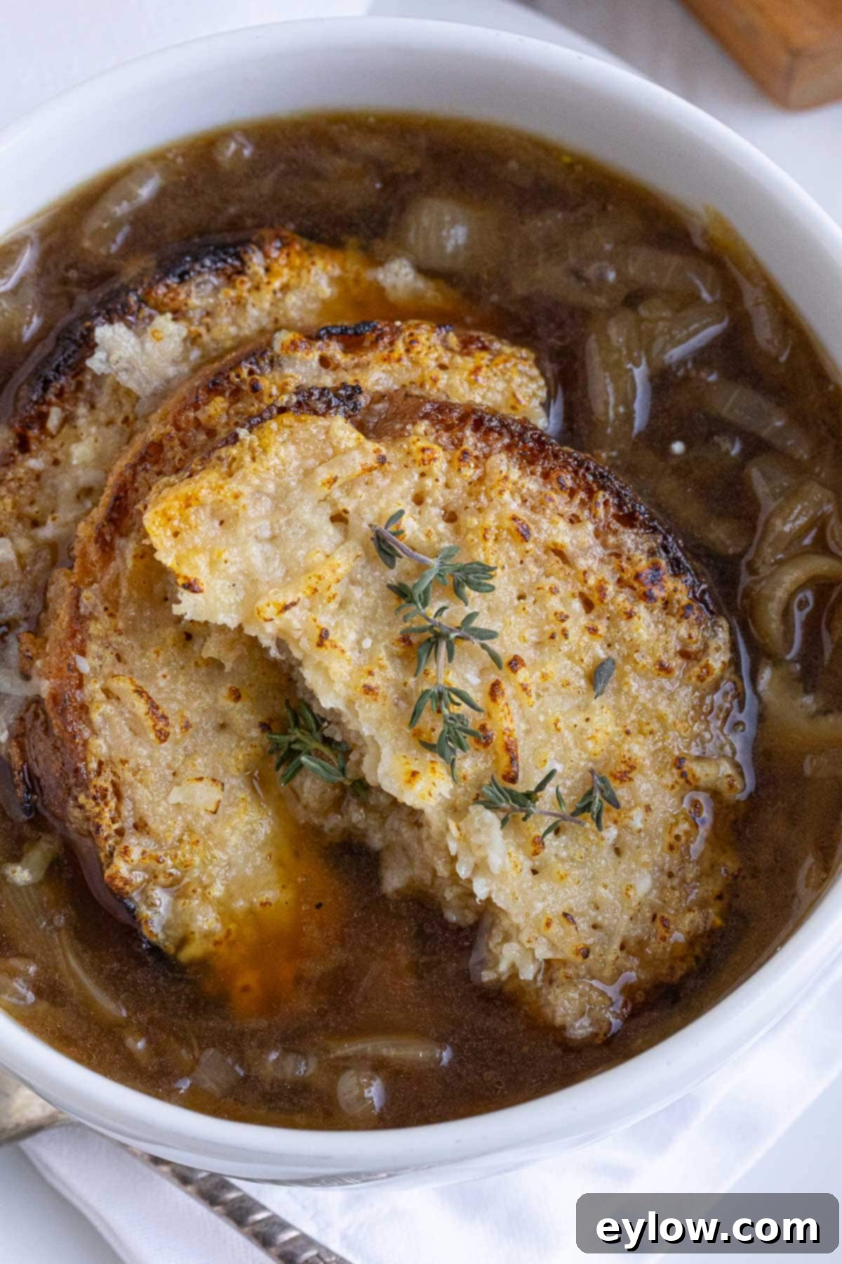 Effortless French Onion Soup 6 Close-up of a bowl of French onion soup, highlighting the rich broth and caramelized onions.