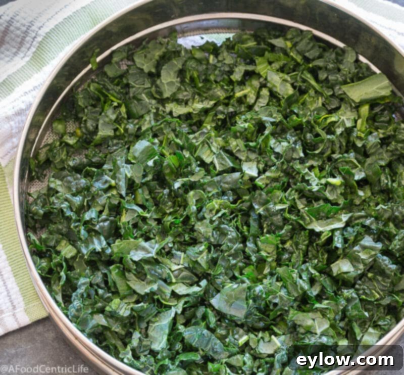 Steamed kale ribbons in a steamer bakset.
