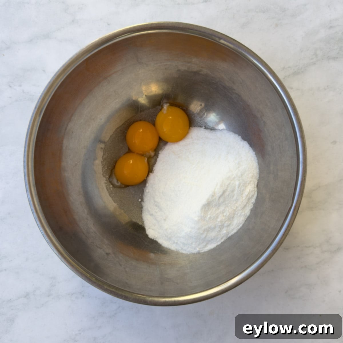 Velvet Pumpkin Mousse No-Bake Treat 5 Adding egg yolks and sugar to a bowl with bloomed gelatin for pumpkin mousse base.