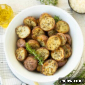 Golden Crispy Red Potatoes: Air Fried or Oven Roasted 8 White bowl of golden browned air fryer red potatoes with rosemary.