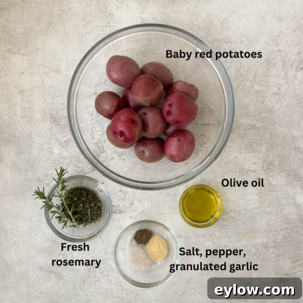 Golden Crispy Red Potatoes: Air Fried or Oven Roasted 3 Baby red potatoes in a glass bowls baby red potatoes, fresh rosemary, seasonings, and olive oil.