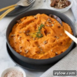 Whipped sweet potatoes ready for serving in a gray bowl.