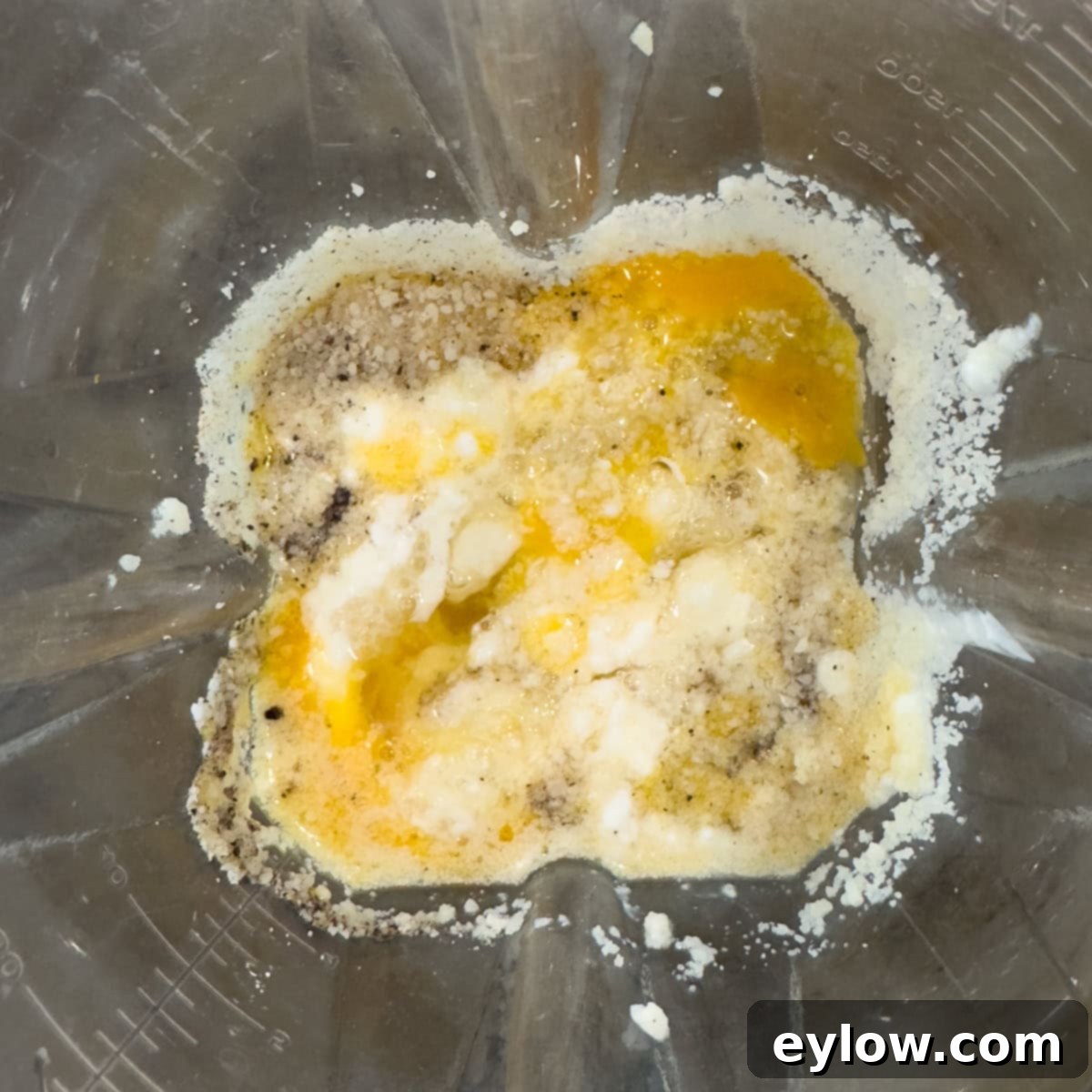 Egg, cottage cheese, and parmesan cheese in a blender ocntainer.