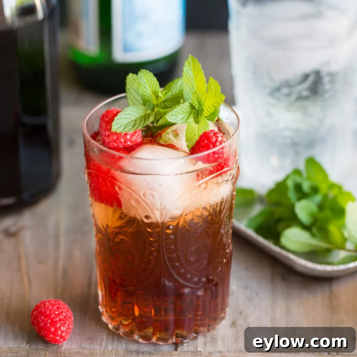 Raspberry Refresher: A Guilt-Free Mocktail 2 Raspberry shrub vinegar drink with fresh raspberries and mint with ice in a tumbler.