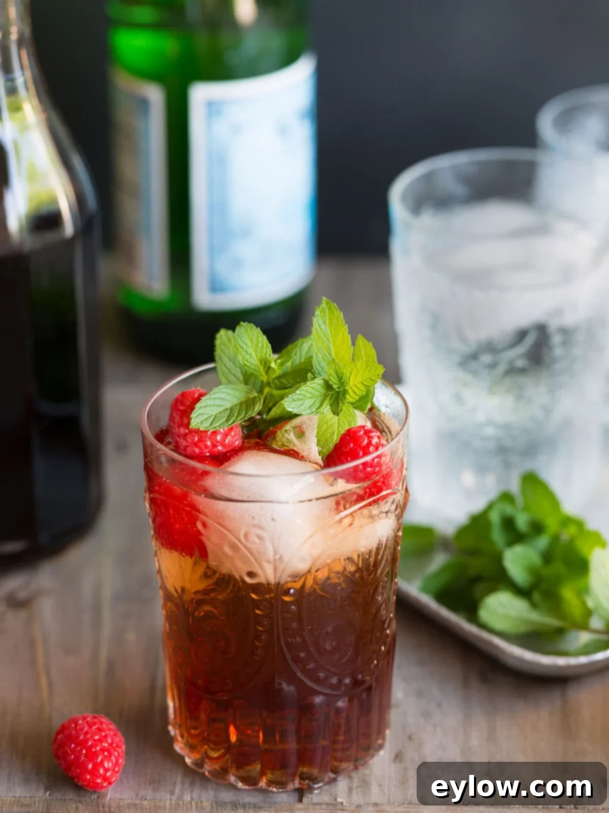 Raspberry Refresher: A Guilt-Free Mocktail 6 A finished raspberry shrub ready to enjoy topped with fresh mint and raspberries.