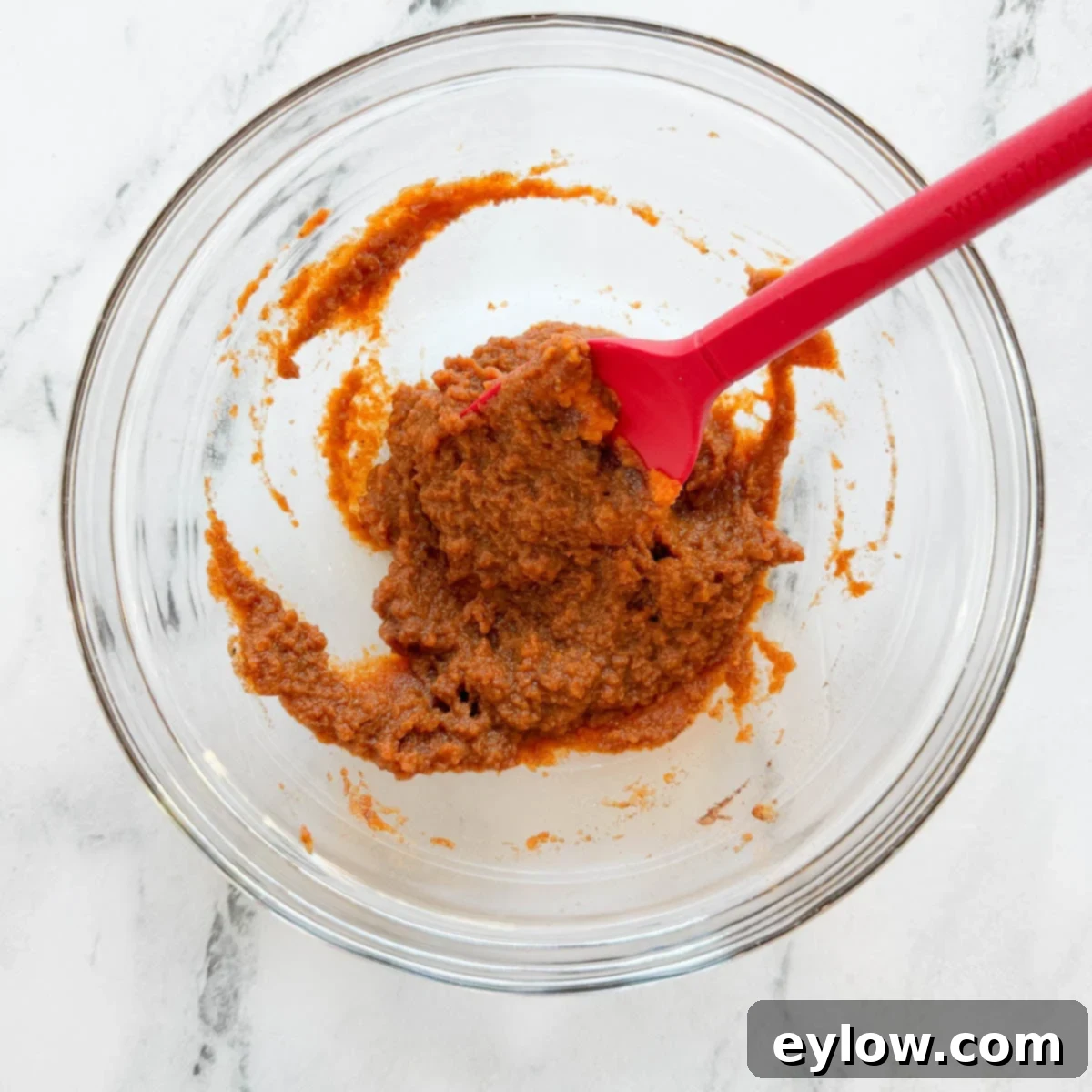 Pumpkin, spices, and maple syrup mixed into a smooth paste.