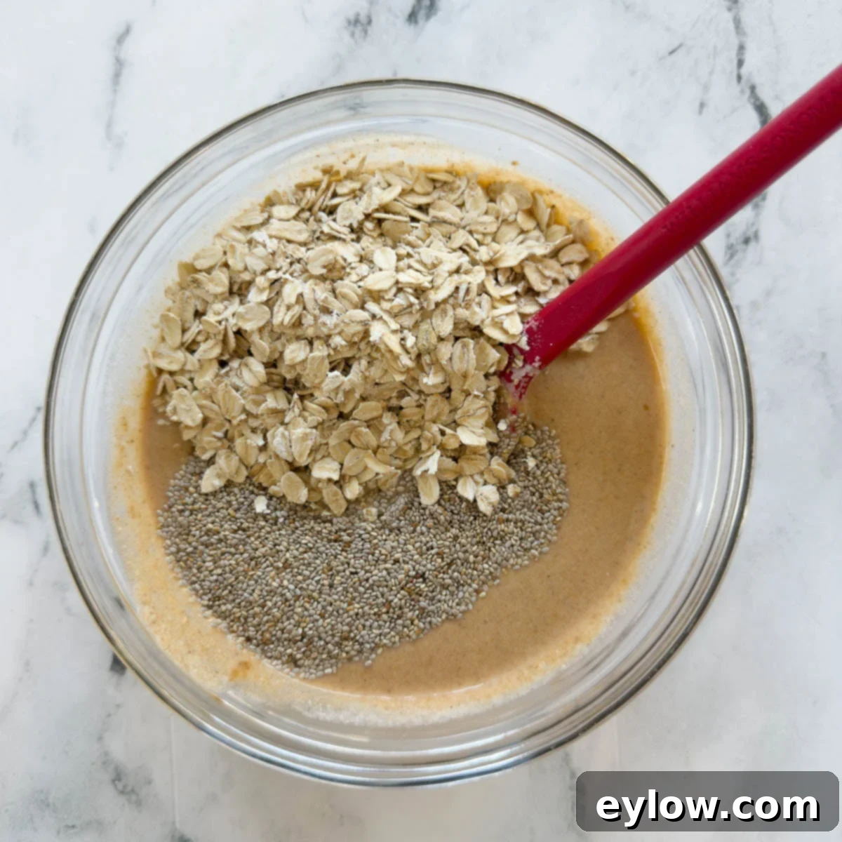 Glass bowl with overnight pumpkin oats base and chia seeds.